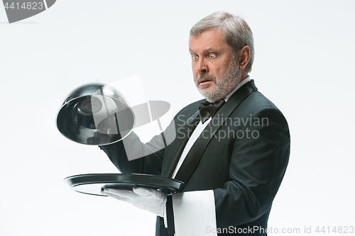 Image of The waiter with tray and metal cloche lid cover