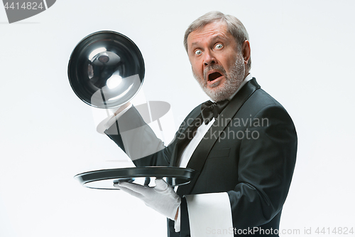 Image of The waiter with tray and metal cloche lid cover