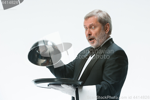 Image of The waiter with tray and metal cloche lid cover