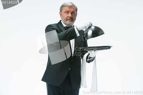 Image of The waiter with tray and metal cloche lid cover