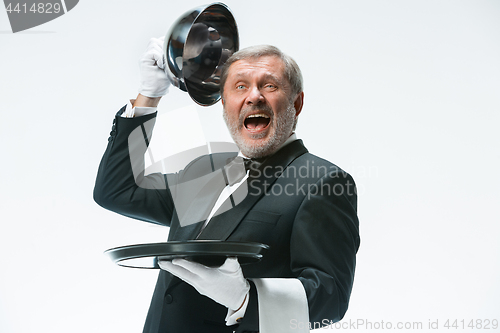 Image of The waiter with tray and metal cloche lid cover