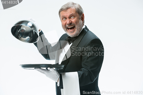 Image of The waiter with tray and metal cloche lid cover