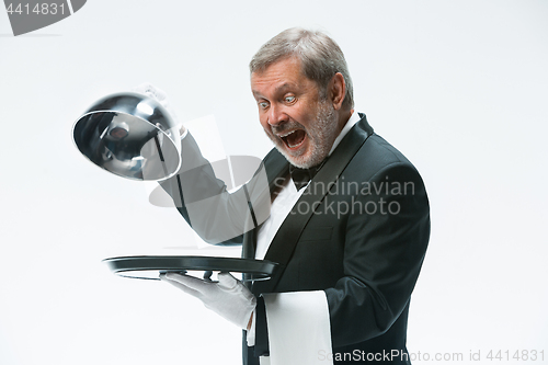 Image of The waiter with tray and metal cloche lid cover