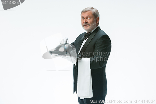 Image of The waiter with tray and metal cloche lid cover