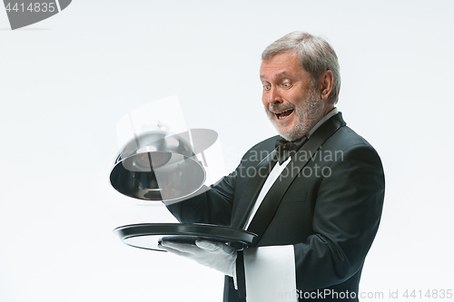 Image of The waiter with tray and metal cloche lid cover