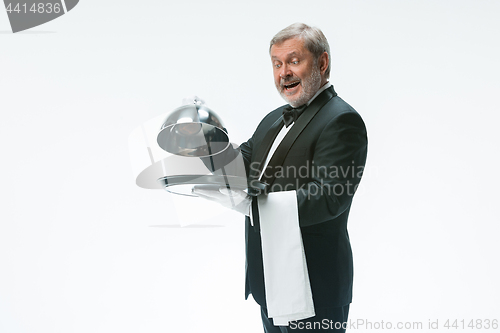 Image of The waiter with tray and metal cloche lid cover