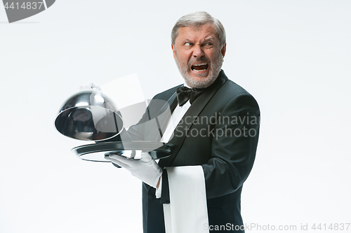 Image of The waiter with tray and metal cloche lid cover