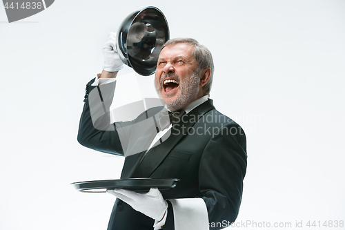 Image of The waiter with tray and metal cloche lid cover
