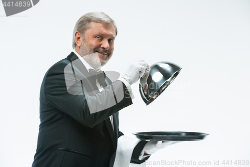 Image of The waiter with tray and metal cloche lid cover