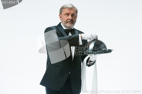 Image of The waiter with tray and metal cloche lid cover