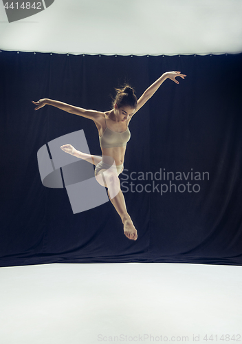 Image of Young teen dancer ion white floor background.