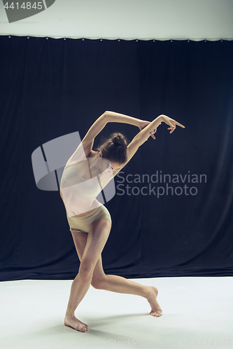 Image of Young teen dancer ion white floor background.