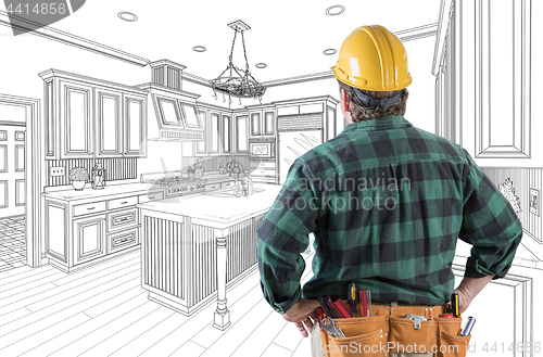 Image of Male Contractor with Hard Hat and Tool Belt Looking At Custom Ki