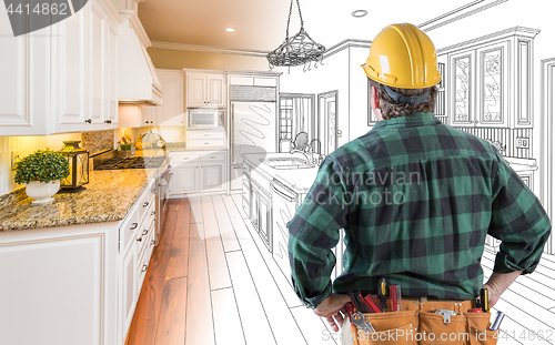 Image of Male Contractor with Hard Hat and Tool Belt Looking At Custom Ki