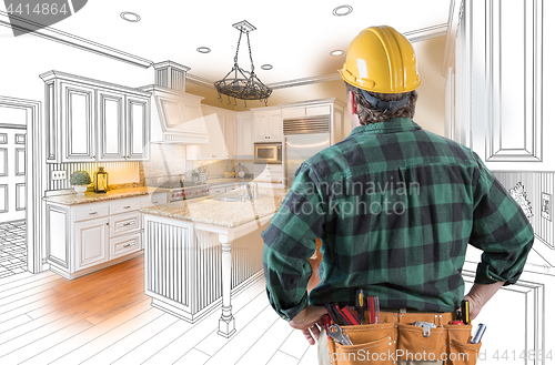 Image of Male Contractor with Hard Hat and Tool Belt Looking At Custom Ki