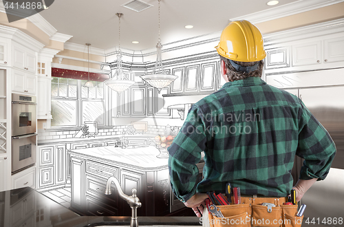 Image of Male Contractor with Hard Hat and Tool Belt Looking At Custom Ki