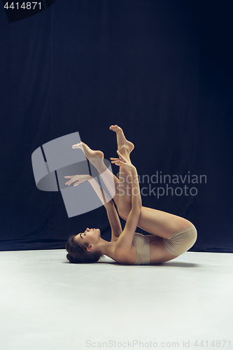 Image of Young teen dancer ion white floor background.