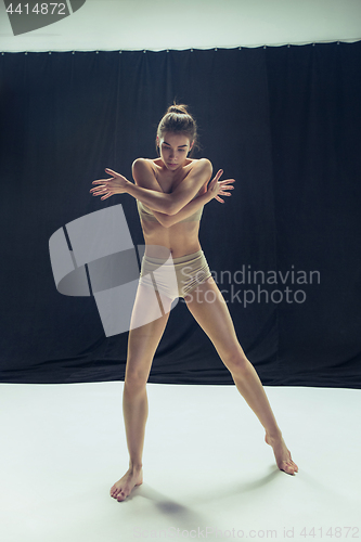 Image of Young teen dancer ion white floor background.