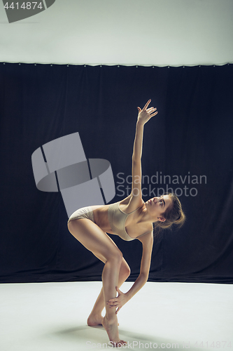 Image of Young teen dancer ion white floor background.