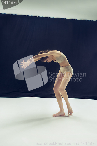 Image of Young teen dancer ion white floor background.