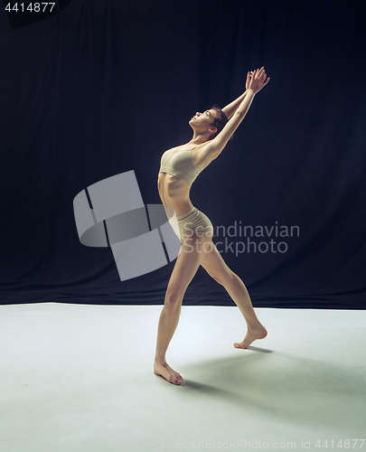 Image of Young teen dancer ion white floor background.