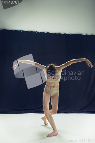 Image of Young teen dancer ion white floor background.