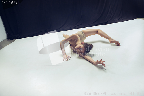 Image of Young teen dancer ion white floor background.