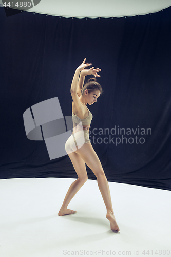 Image of Young teen dancer ion white floor background.