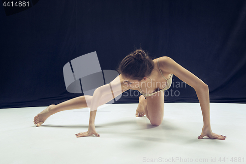 Image of Young teen dancer ion white floor background.