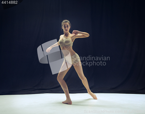 Image of Young teen dancer ion white floor background.