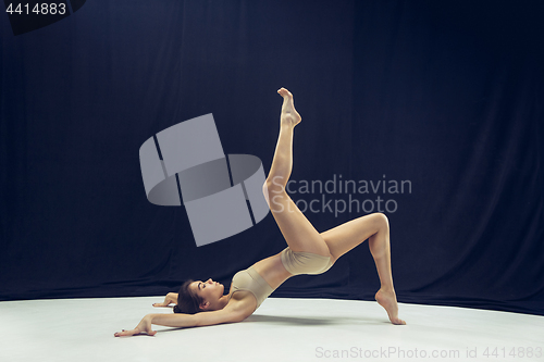 Image of Young teen dancer ion white floor background.