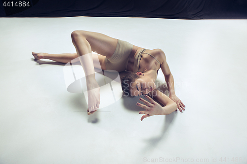 Image of Young teen dancer ion white floor background.