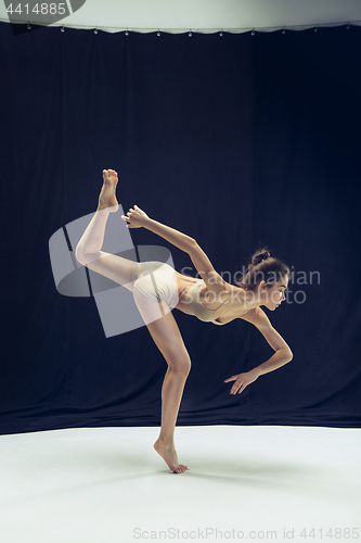 Image of Young teen dancer ion white floor background.