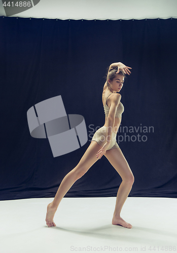 Image of Young teen dancer ion white floor background.