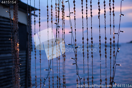 Image of Strings of seashells and christmas lights