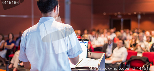 Image of Public speaker giving talk at Business Event.