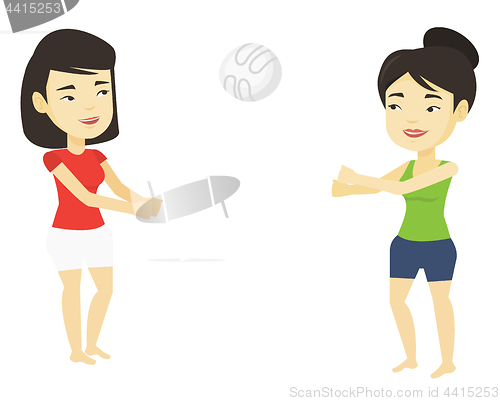 Image of Two women playing beach volleyball.