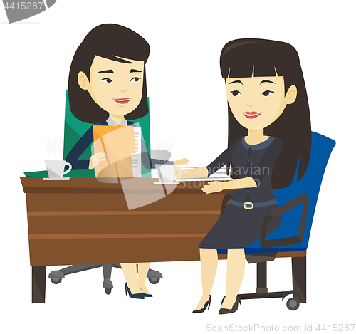 Image of Two businesswomen during business meeting.