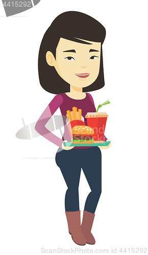 Image of Woman holding tray full of fast food.
