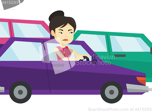 Image of Angry asian woman in car stuck in traffic jam.