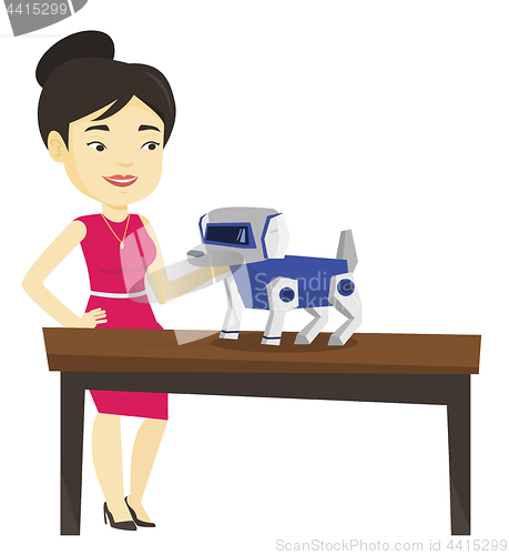 Image of Happy young woman playing with robotic dog.