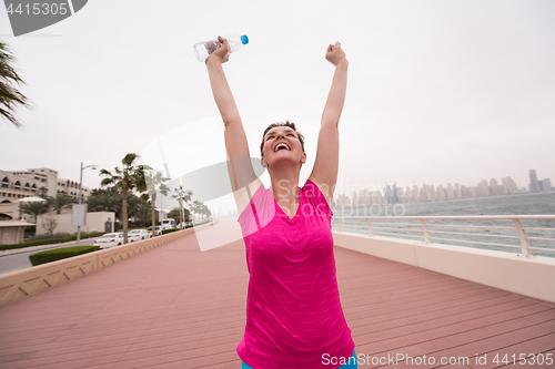 Image of young woman celebrating a successful training run