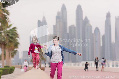 Image of mother and cute little girl on the promenade