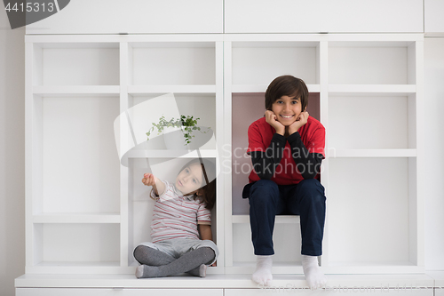 Image of young boys posing on a shelf