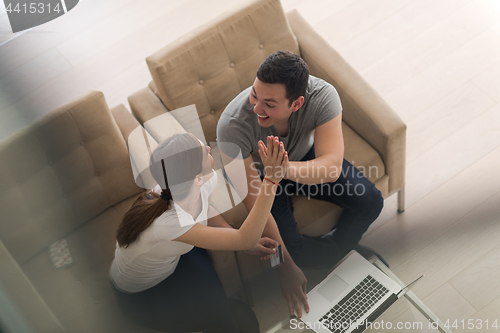 Image of happy young couple buying online