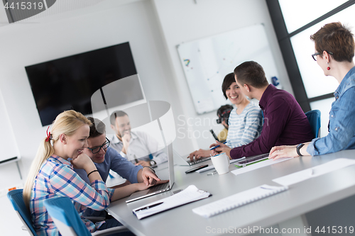 Image of Two Business People Working With laptop in office