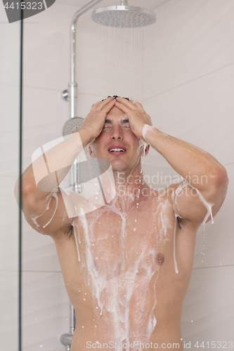 Image of man taking shower in bath