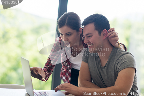 Image of happy young couple buying online