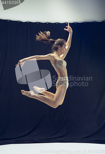 Image of Young teen dancer ion white floor background.