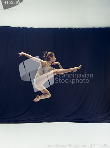 Image of Young teen dancer ion white floor background.